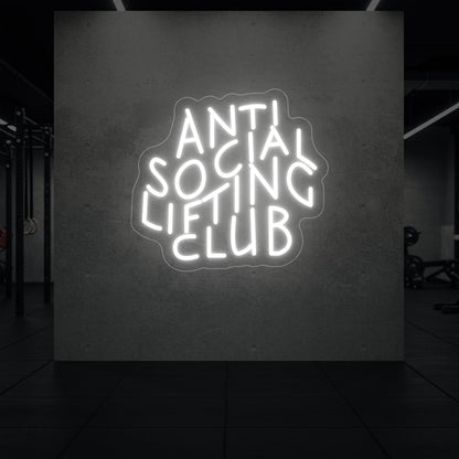  'Anti Social Lifting Club' neon sign glowing in cool white against a styled interior wall.
