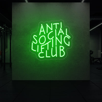 'Anti Social Lifting Club' neon sign glowing in green against a styled interior wall.