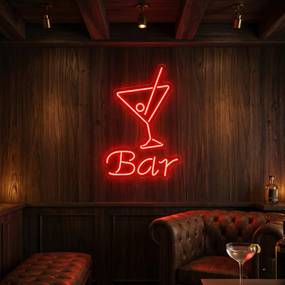 Photo of the 'BAR' neon sign glowing in red against a styled interior wall.