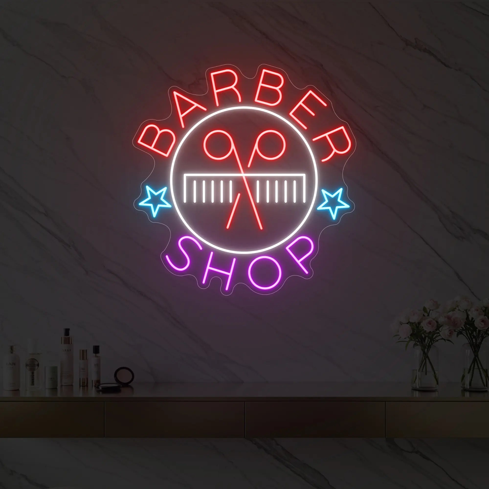Photo of the 'Barber Shop' neon sign glowing in multi-color against a styled interior wall.