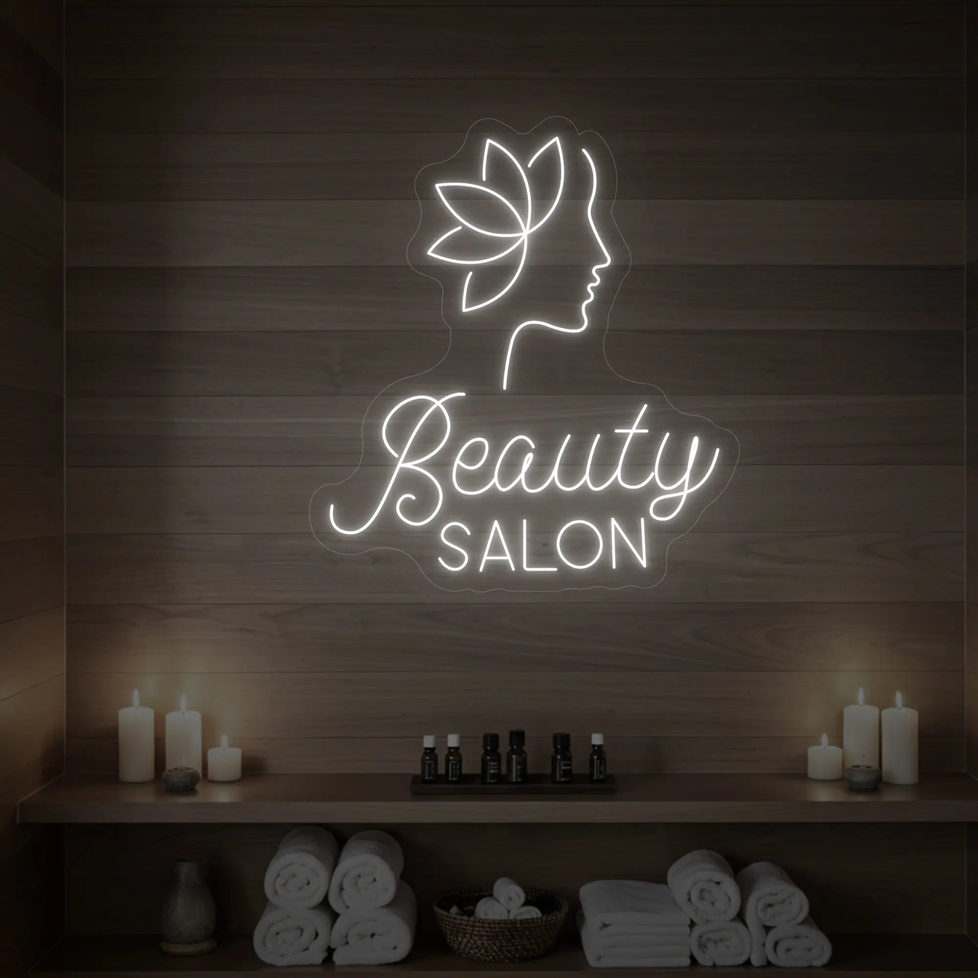 Photo of the 'Beauty Salon' neon sign glowing in cool white against a styled interior wall.
