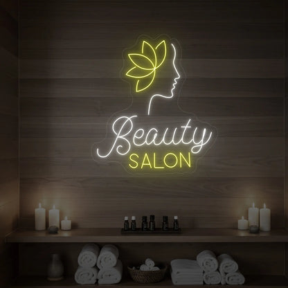 Photo of the 'Beauty Salon' neon sign glowing in cool white and lemon yellow against a styled interior wall.