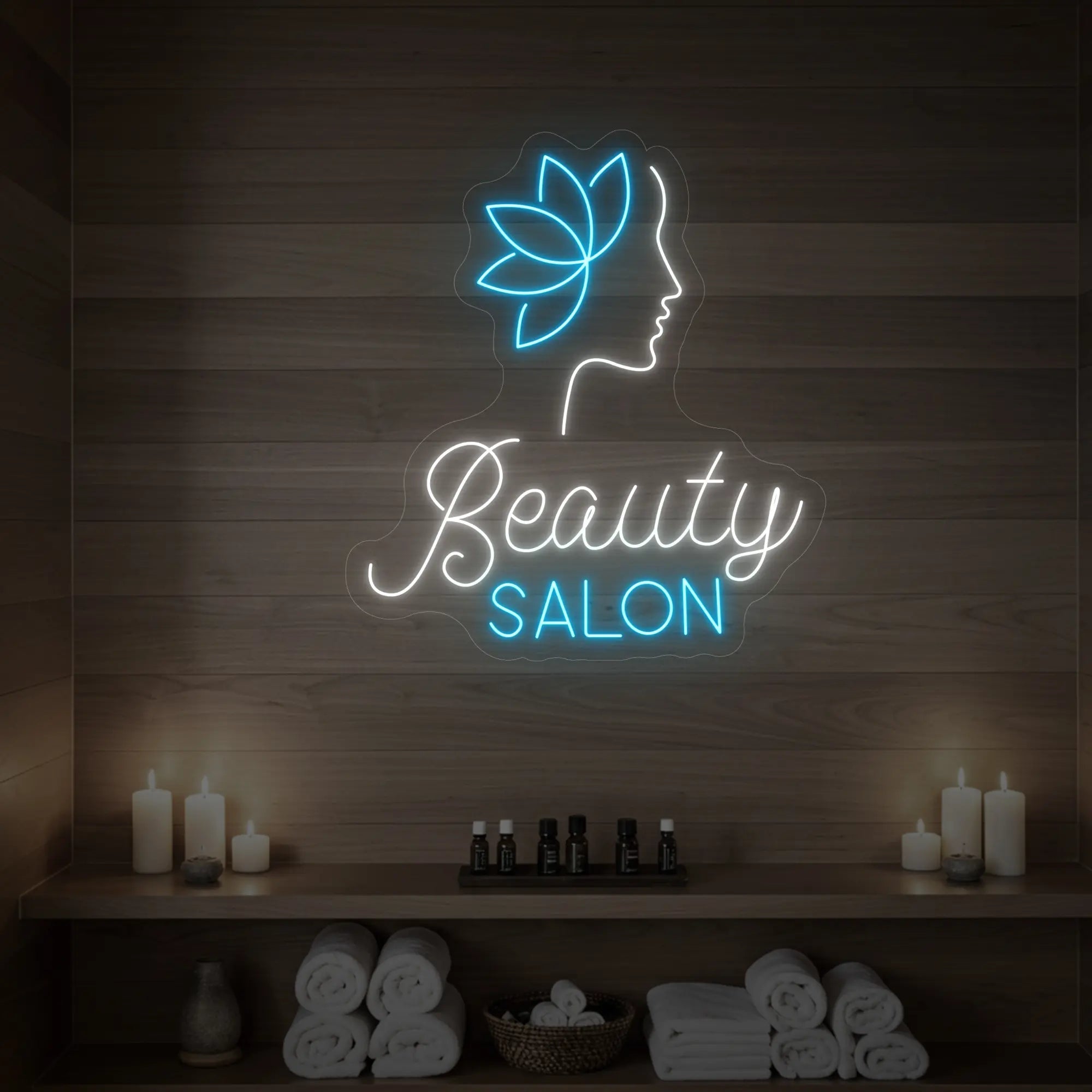Photo of the 'Beauty Salon' neon sign glowing in cool white and ice blue against a styled interior wall.