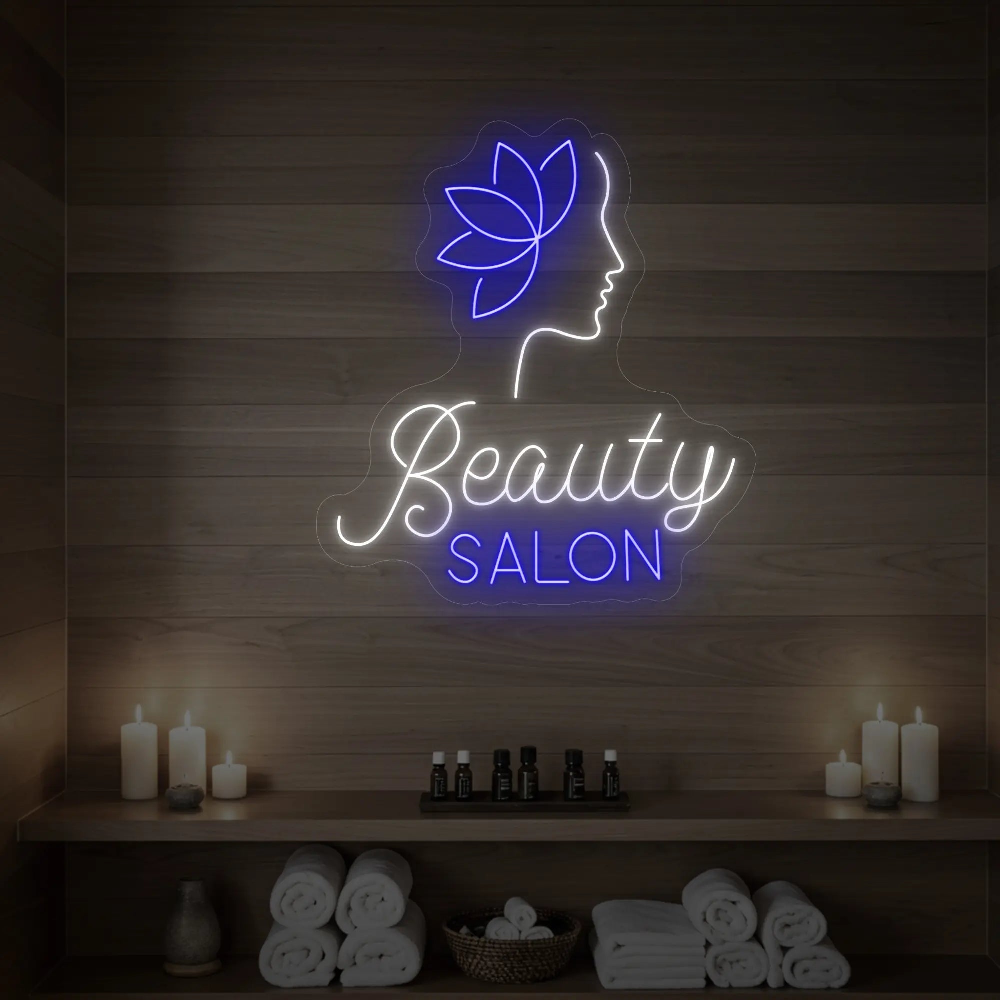 Photo of the 'Beauty Salon' neon sign glowing in cool white and deep blue against a styled interior wall.