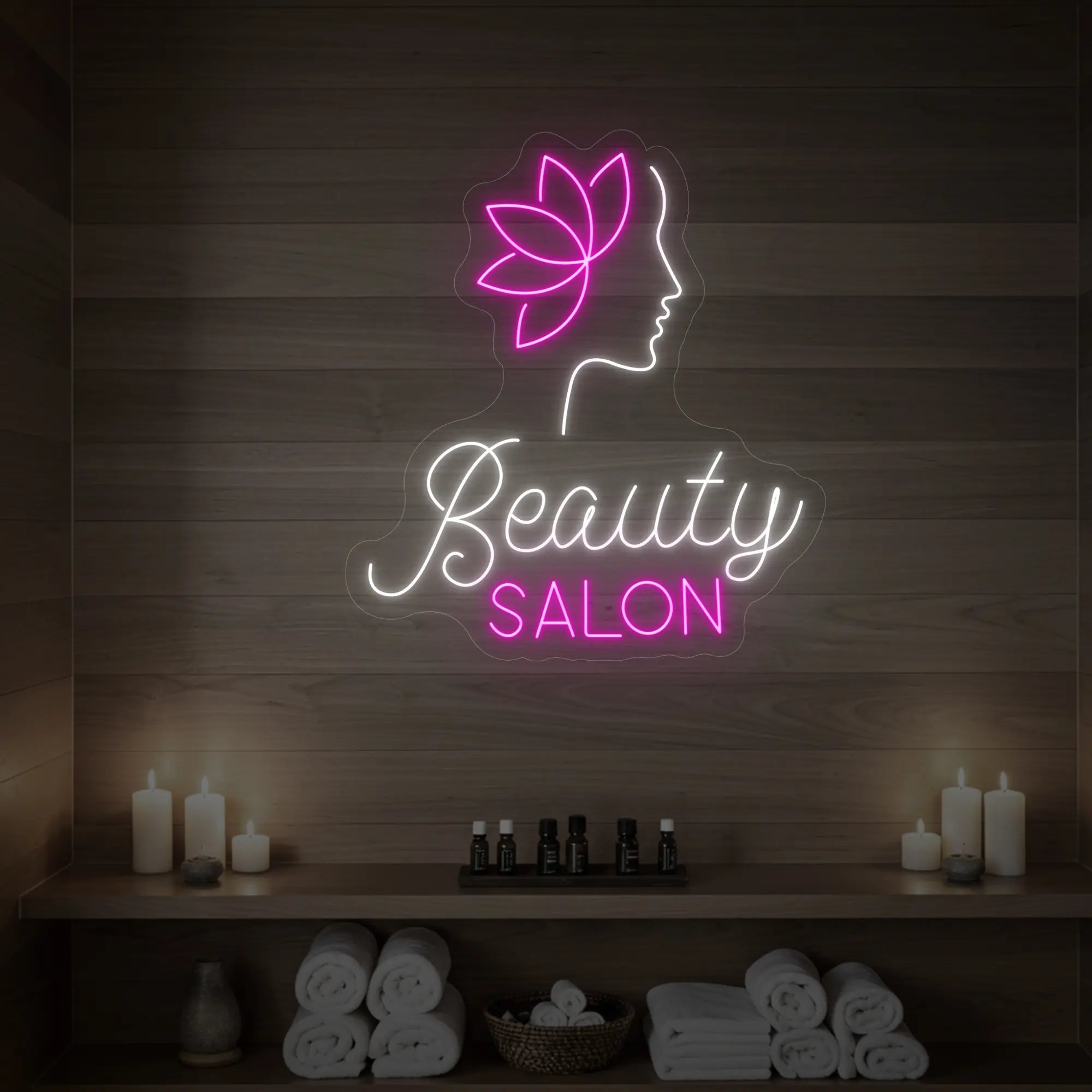 Photo of the 'Beauty Salon' neon sign glowing in cool white and light pink against a styled interior wall.
