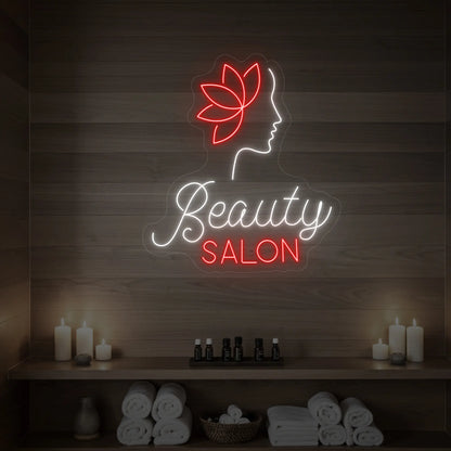 Photo of the 'Beauty Salon' neon sign glowing in cool white and red against a styled interior wall.