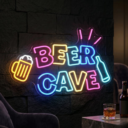 Photo of the 'BEER CAVE' neon sign glowing in multicolor against a styled interior wall.