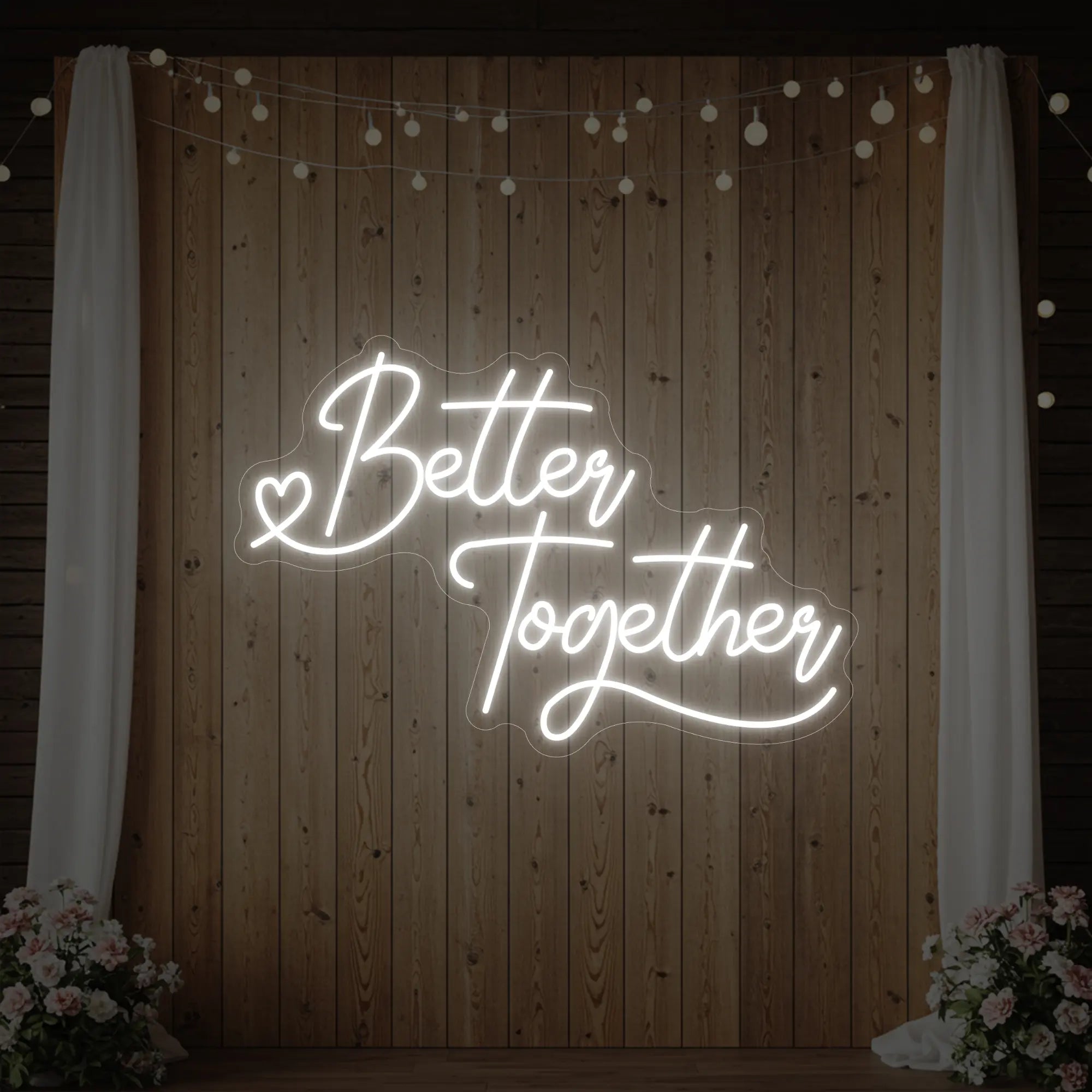 Photo of the 'Better Together' neon sign glowing in cool white against a styled interior wall.