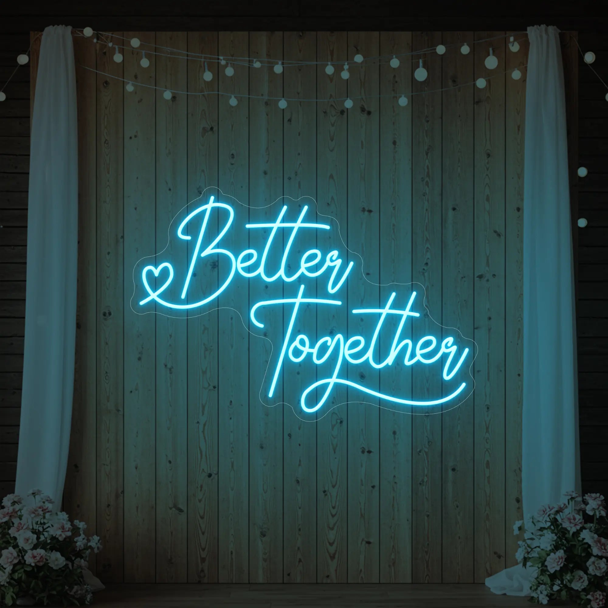 Photo of the 'Better Together' neon sign glowing in ice blue against a styled interior wall.