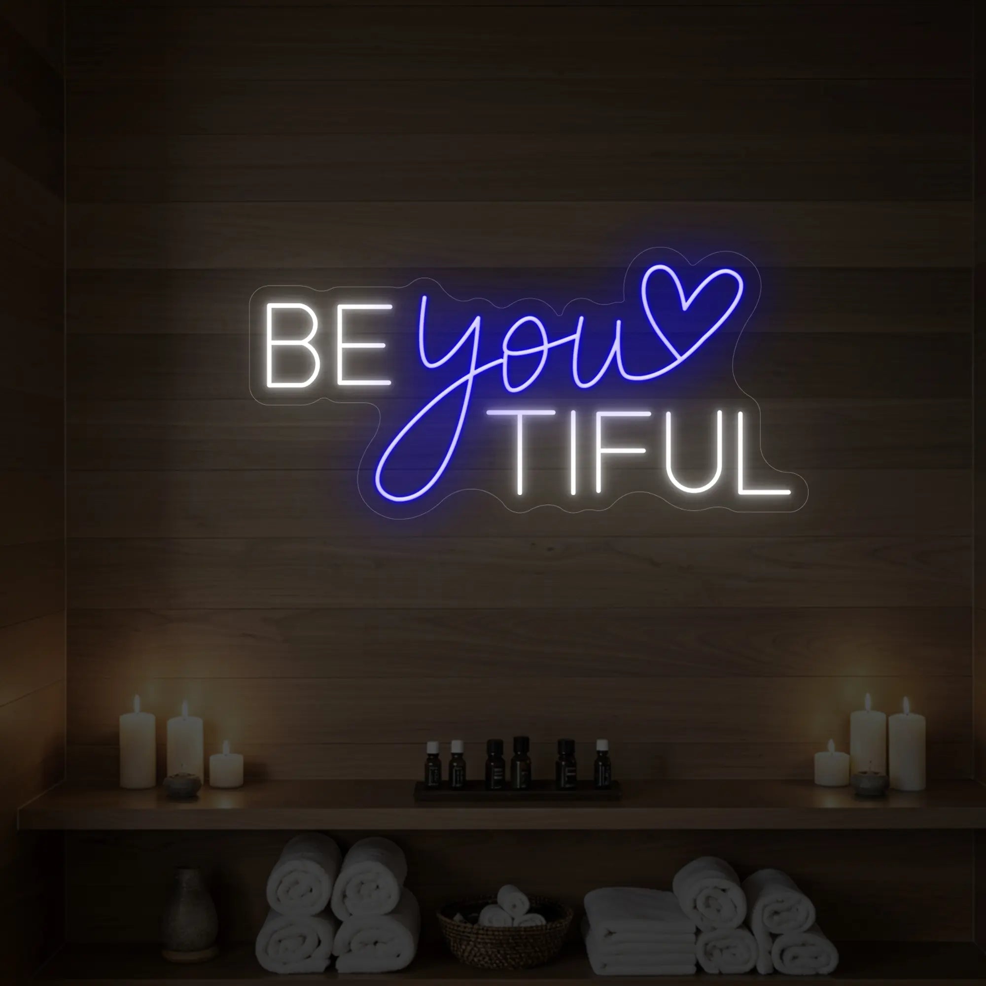 Photo of the 'BEYOUtiful' neon sign glowing in deep blue against a styled interior wall.