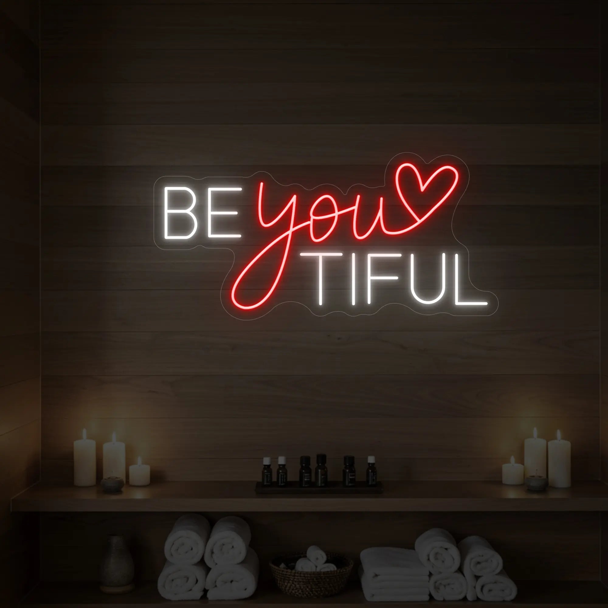 Photo of the 'BEYOUtiful' neon sign glowing in red against a styled interior wall.