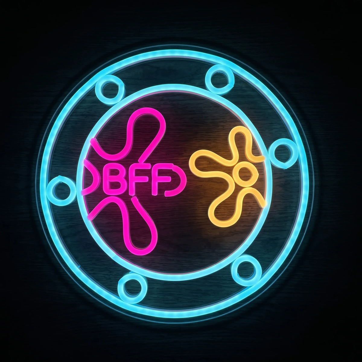 BFF friendship LED neon sign with pink, cyan blue and yellow-orange illumination on acrylic backing.