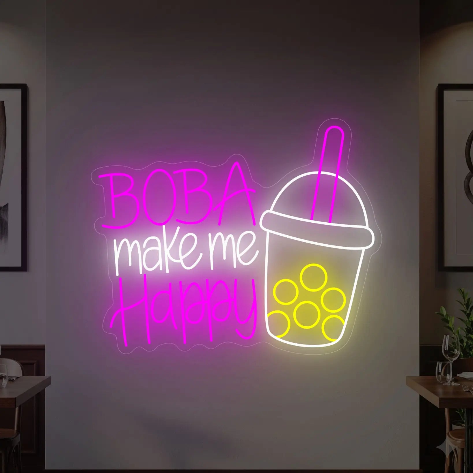 Photo of the 'BOBA MAKE ME HAPPY' neon sign glowing in cool white, deep pink and yellow against a styled interior wall.