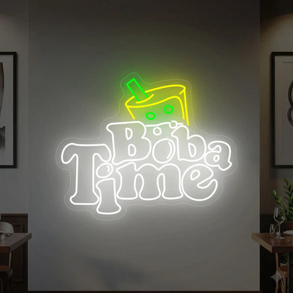 Photo of the 'BOBA TIME' neon sign glowing in cool white, green and yellow against a styled interior wall.