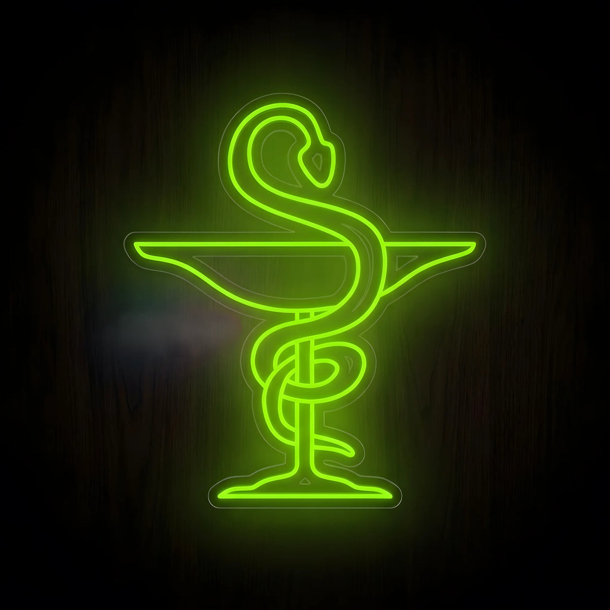 Green Bowl of Hygieia Pharmacy LED Neon Sign featuring a glowing serpent wrapped around a pharmacy bowl on clear acrylic backing against a dark wooden wall.
