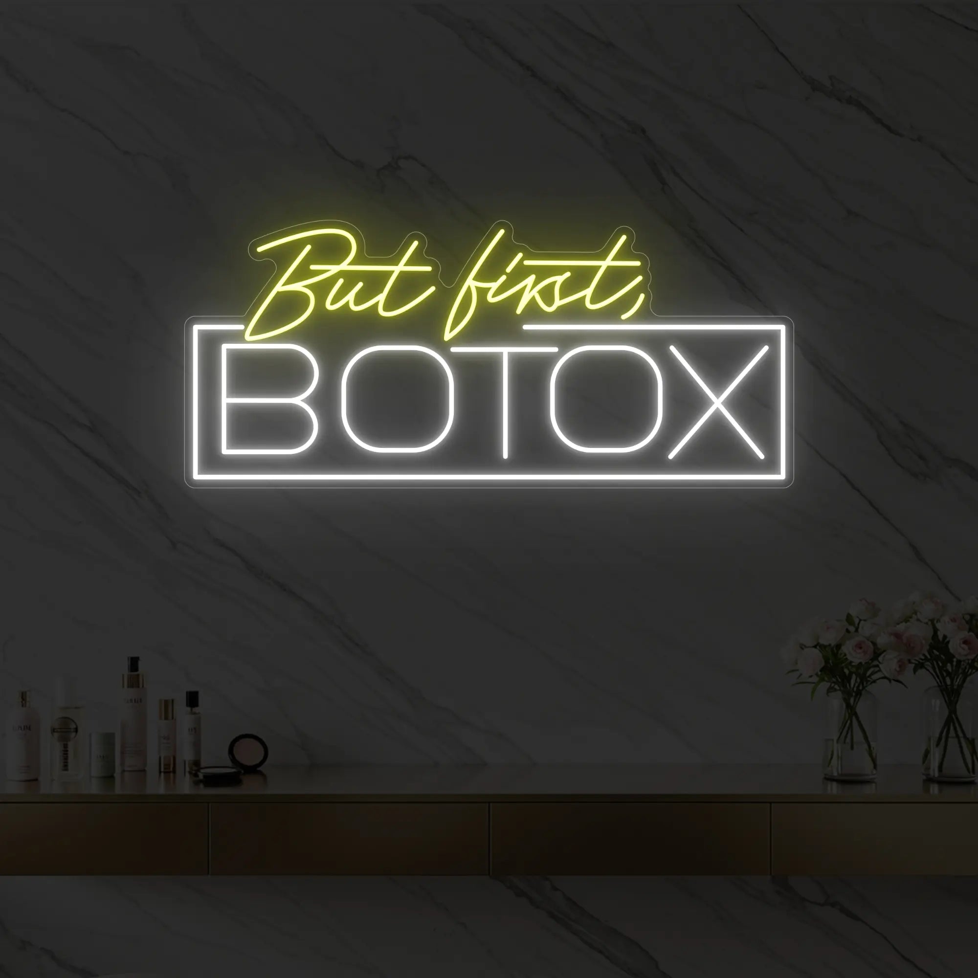 Photo of the 'But first, BOTOX' neon sign glowing in lemon yellow against a styled interior wall.