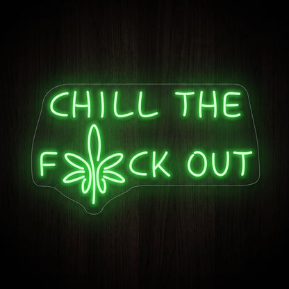 Chill The F*ck Out LED neon sign featuring bright green lettering with a cannabis leaf integrated into the phrase on a clear acrylic backing.