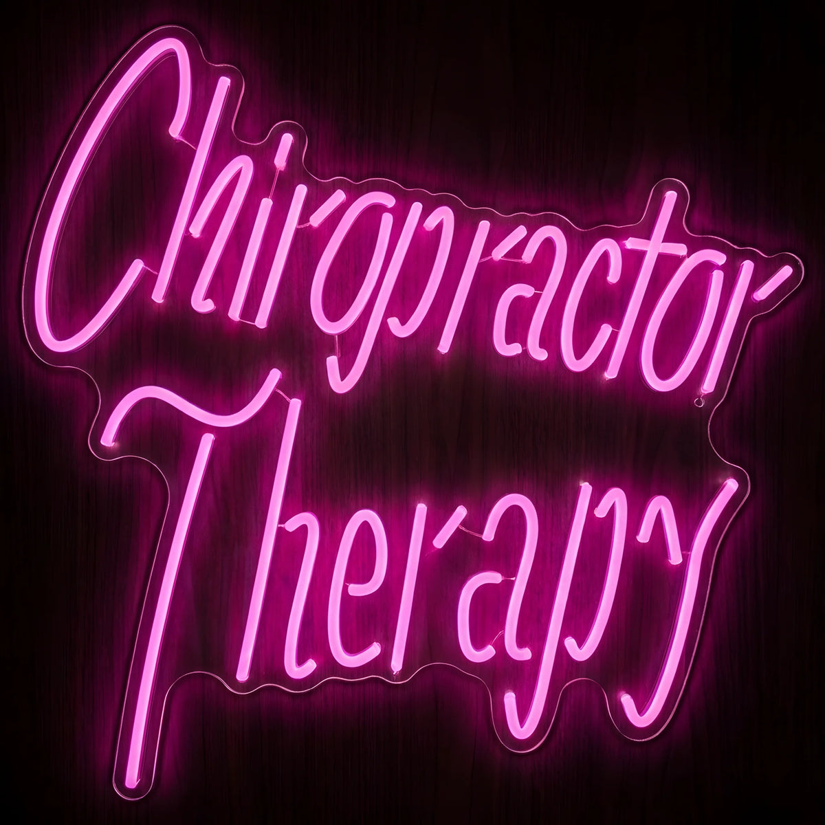Chiropractor Therapy LED neon sign featuring vibrant pink cursive lettering on clear acrylic backing for chiropractic offices, wellness clinics, and therapy room wall decor.