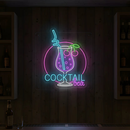Photo of the 'COCKTAIL BAR' neon sign glowing in multi-color against a styled interior wall.