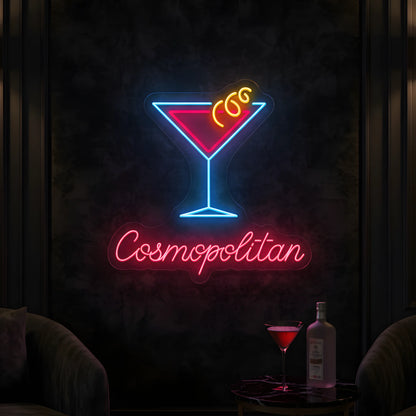 Photo of the 'Cosmopolitan' neon sign glowing in multi-color against a stylish cocktail lounge-inspired wall.
