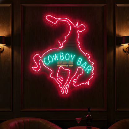 Photo of the 'Cowboy Bar' neon sign glowing in multi-color against a western-inspired bar wall.