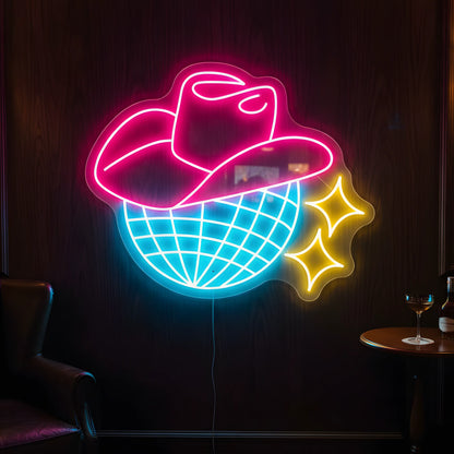 Photo of the 'Cowboy Disco' neon sign glowing in multi-color against a western disco-inspired wall.
