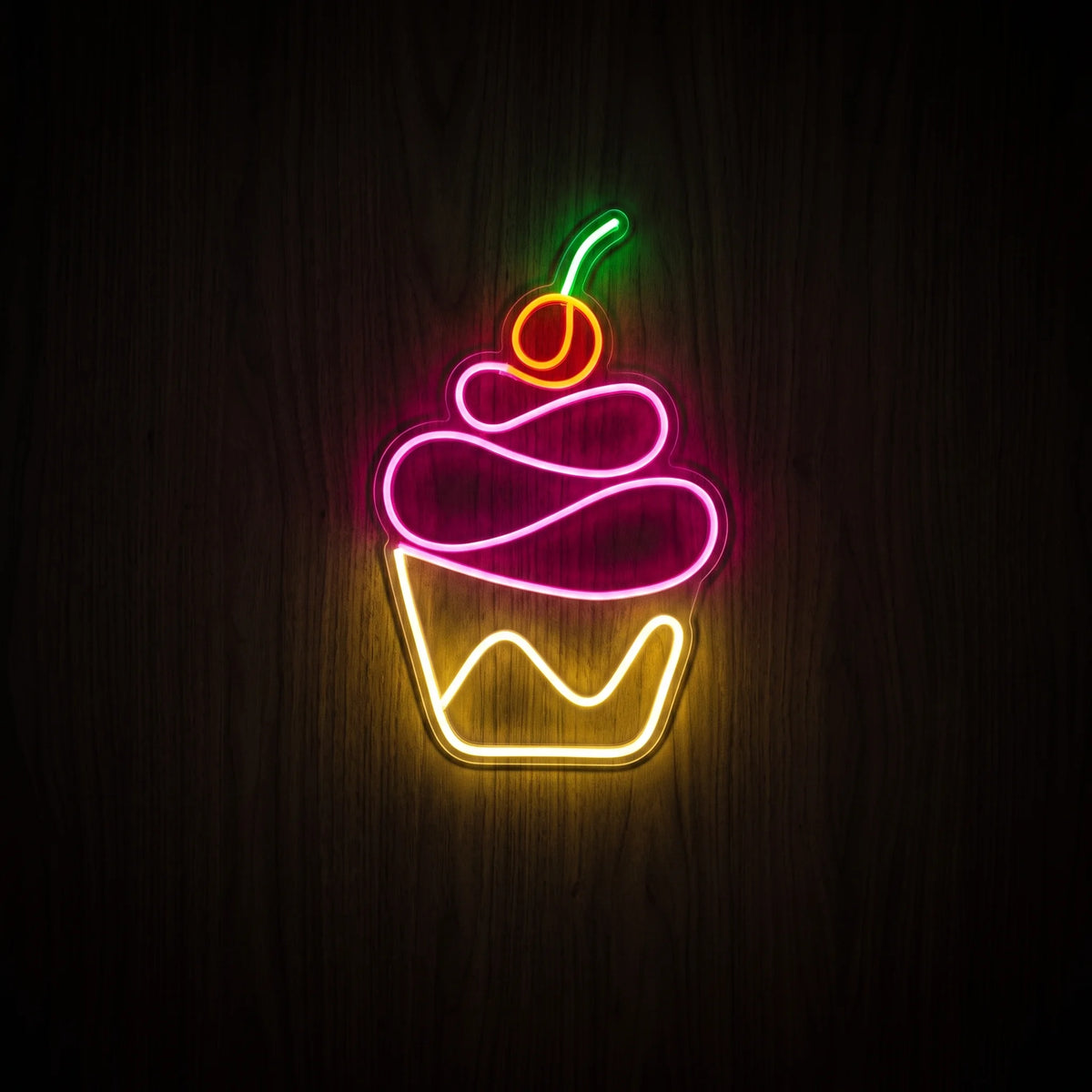 Cupcake LED neon sign with pink frosting, yellow wrapper, orange-red cherry, green stem, and clear acrylic backing.
