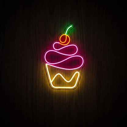 Cupcake LED neon sign with pink frosting, yellow wrapper, orange-red cherry, green stem, and clear acrylic backing.
