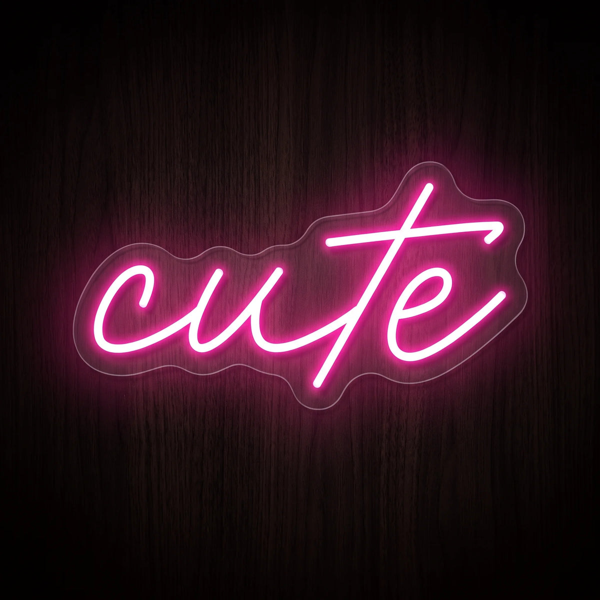 Cute Script LED neon sign featuring the word cute in flowing handwritten lettering illuminated in bright pink on clear acrylic backing.