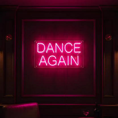 Photo of the 'DANCE AGAIN' neon sign glowing in pink against a modern nightclub-inspired wall.
