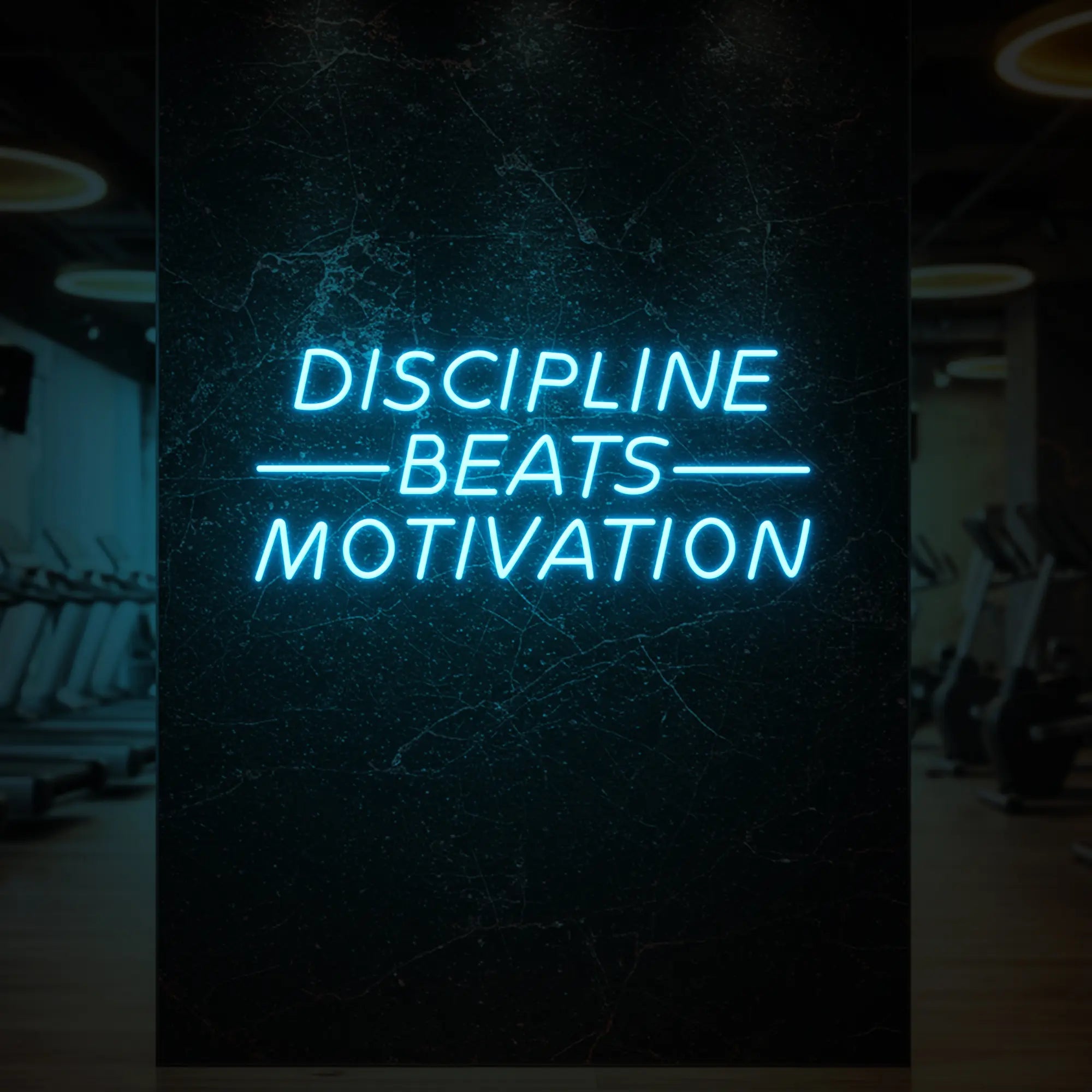 'Discipline Beats Motivation' neon sign glowing in warm white against a styled interior wall.