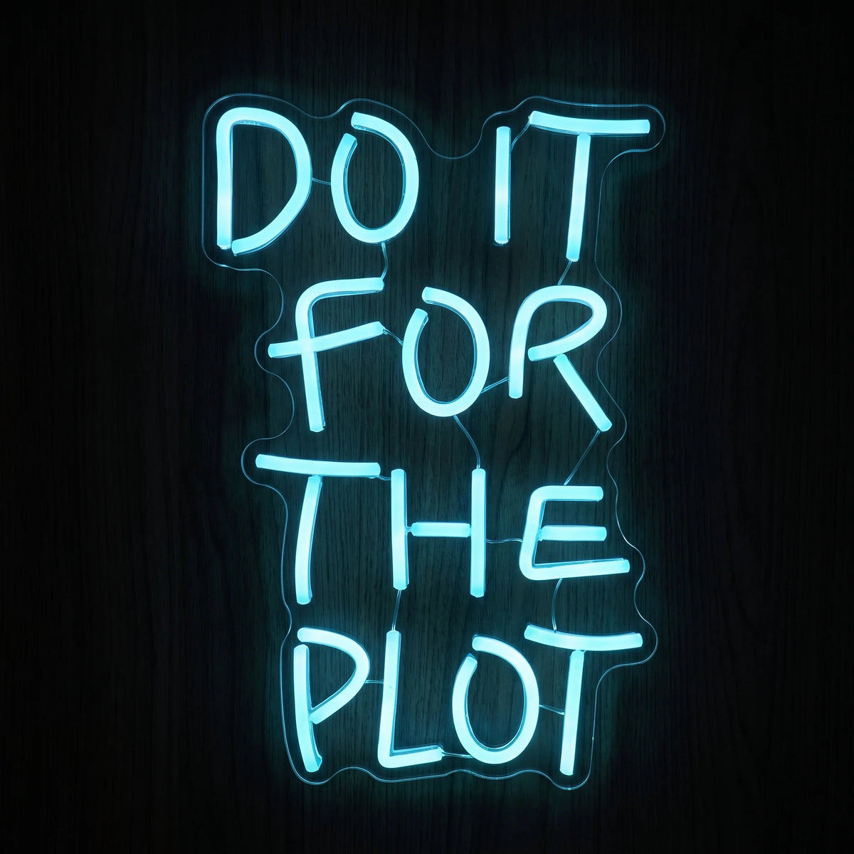 Do It For The Plot LED neon sign in bright cool blue on clear acrylic backing.