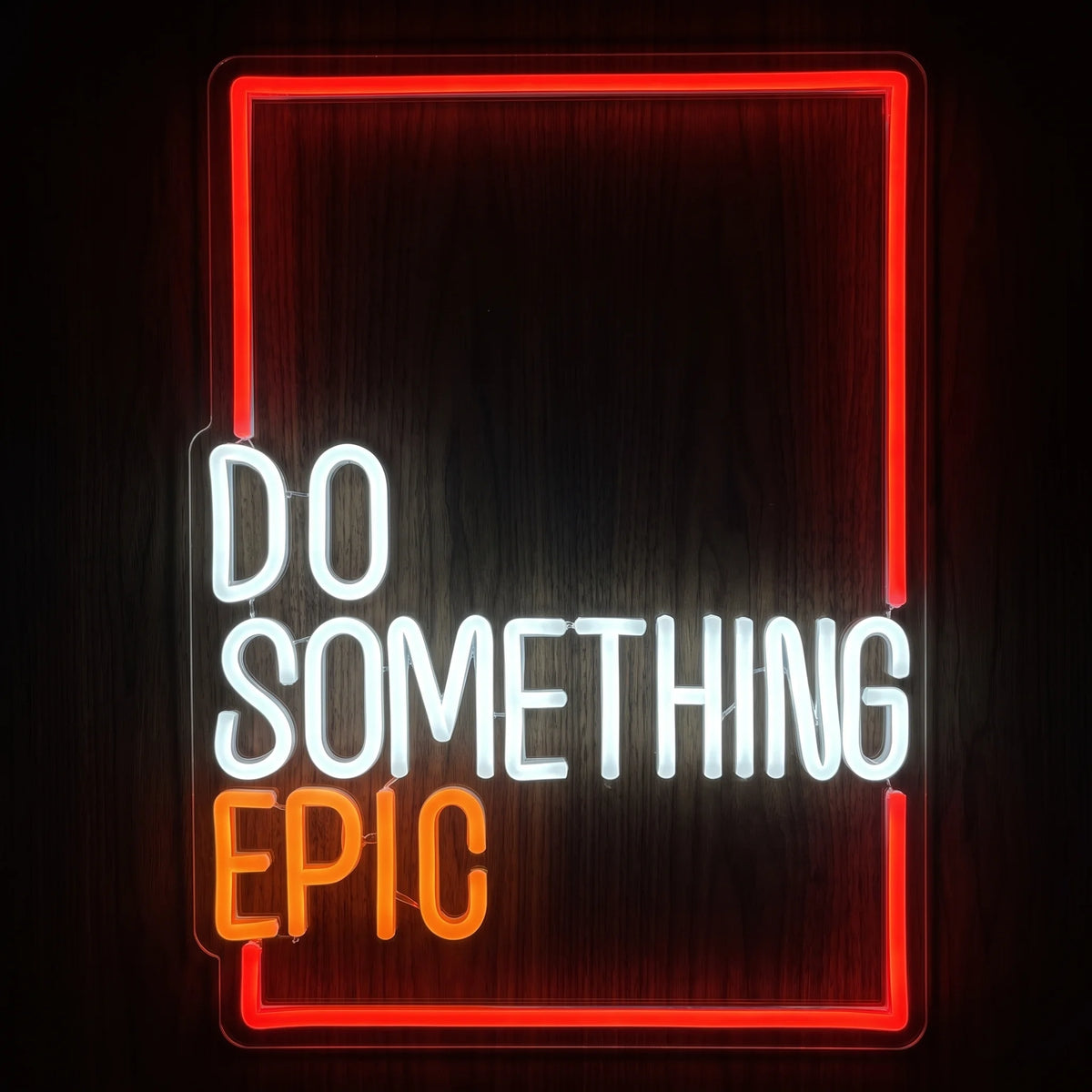 Do Something Epic LED neon sign with white and orange lettering, red illuminated border, and clear acrylic backing.