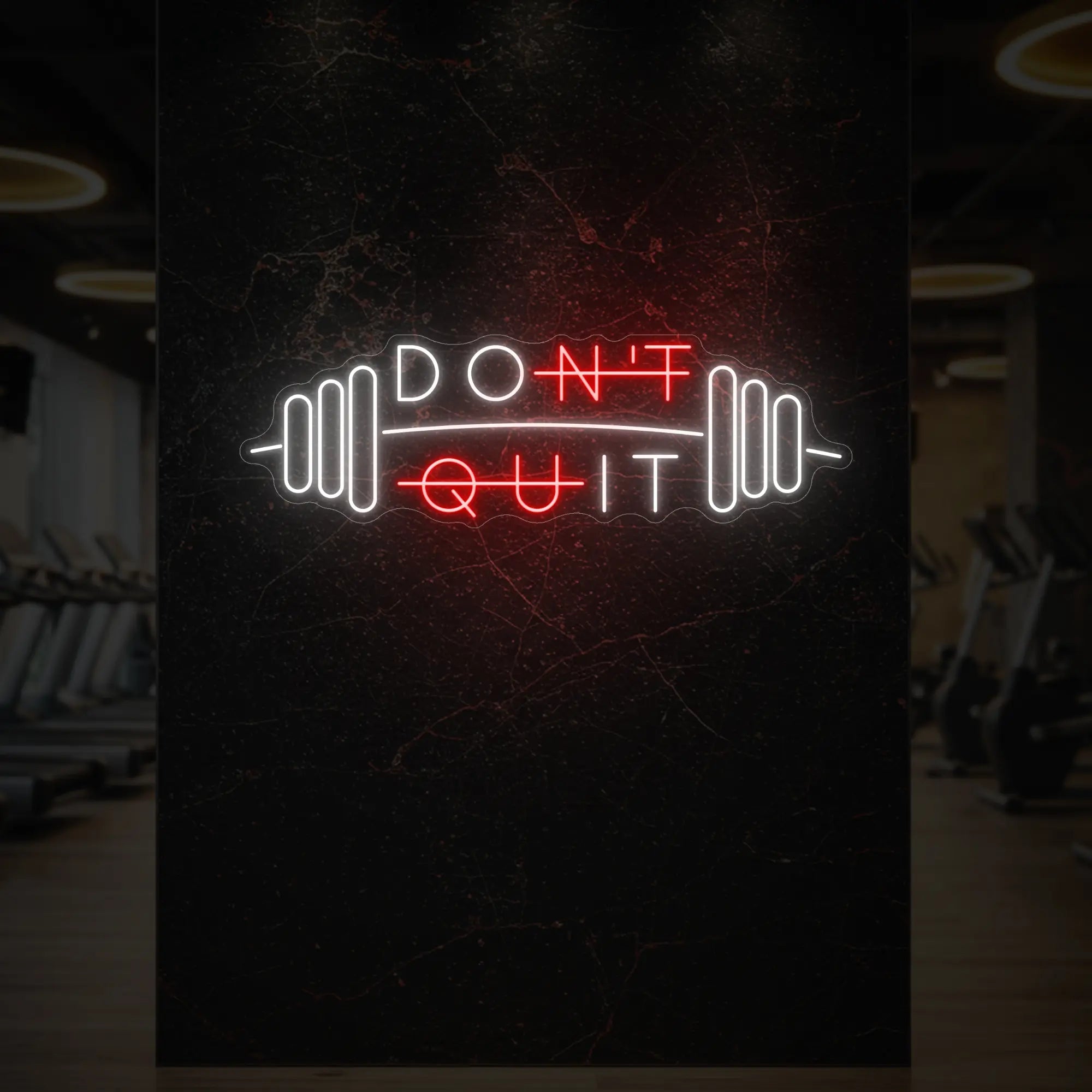 'Don’t Quit (with Barbell)' neon sign glowing in red against a styled interior wall.