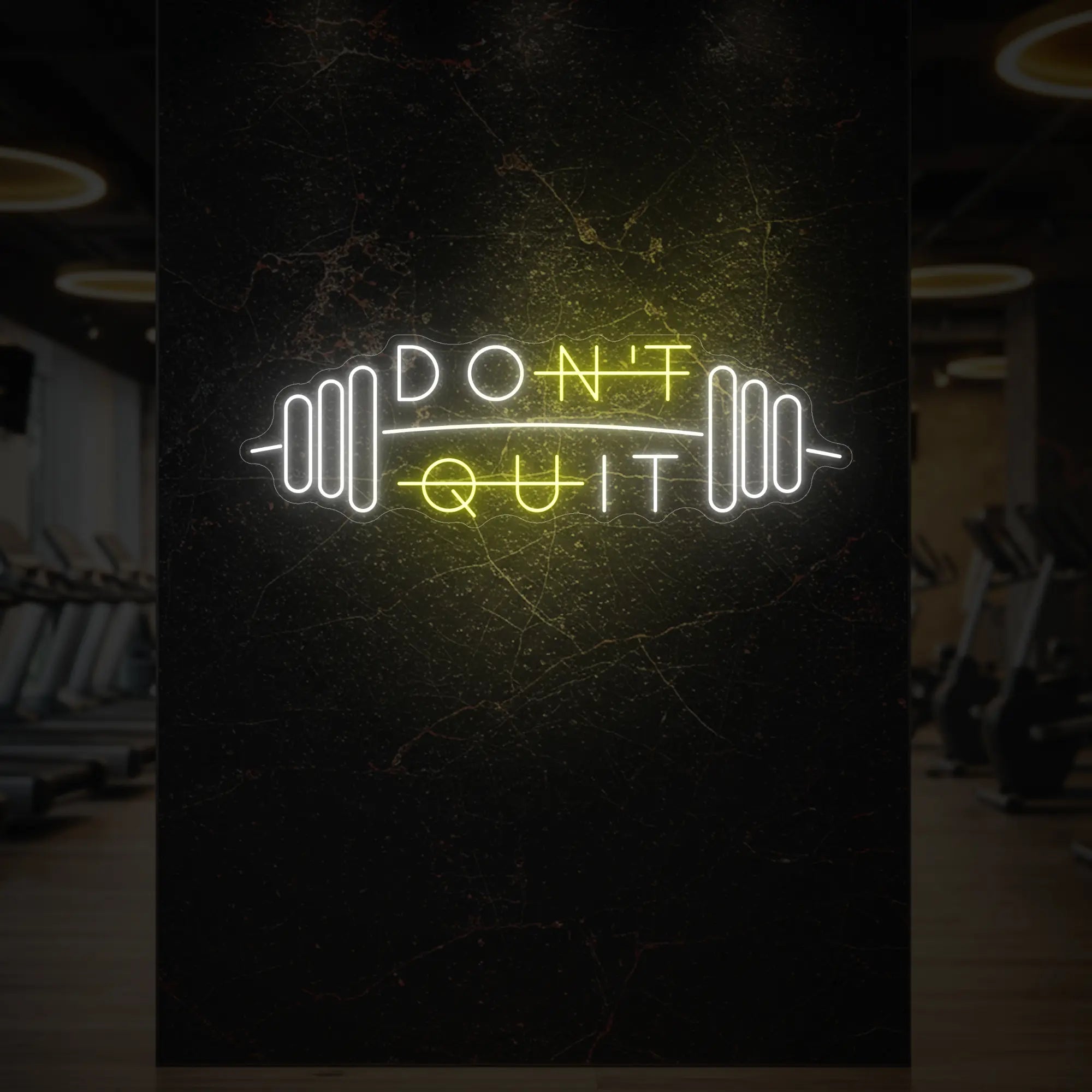 'Don’t Quit (with Barbell)' neon sign glowing in lemon yellow against a styled interior wall.