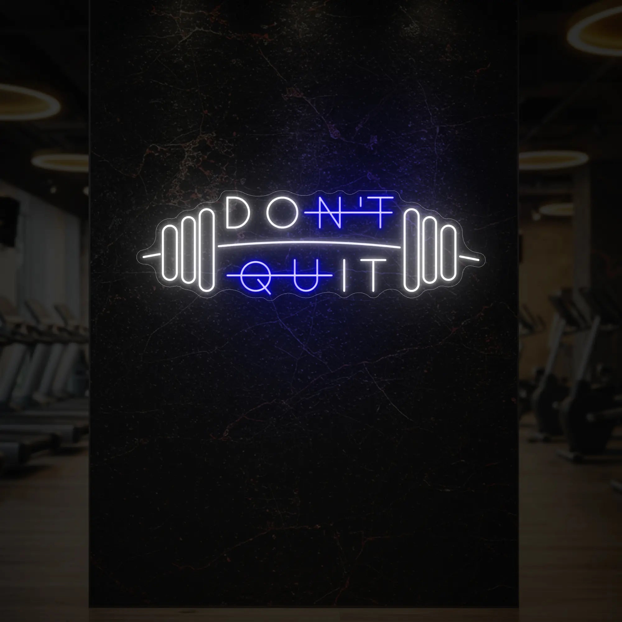 'Don’t Quit (with Barbell)' neon sign glowing in deep blue against a styled interior wall.