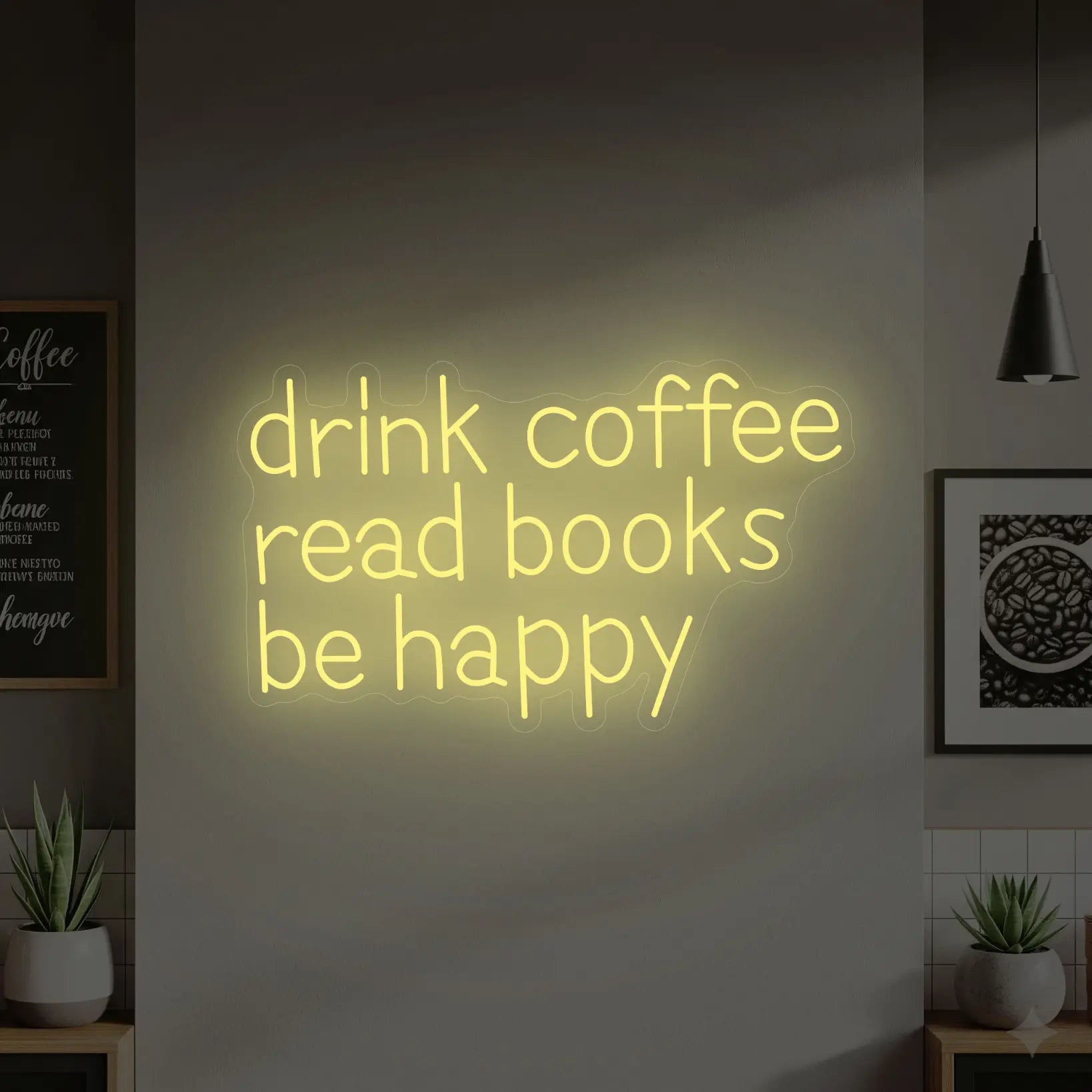 Photo of the 'DRINK COFFEE READ BOOKS BE HAPPY' neon sign glowing in warm white against a styled interior wall.