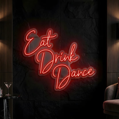 Photo of the 'Eat Drink Dance' neon sign glowing in red against a styled interior wall.