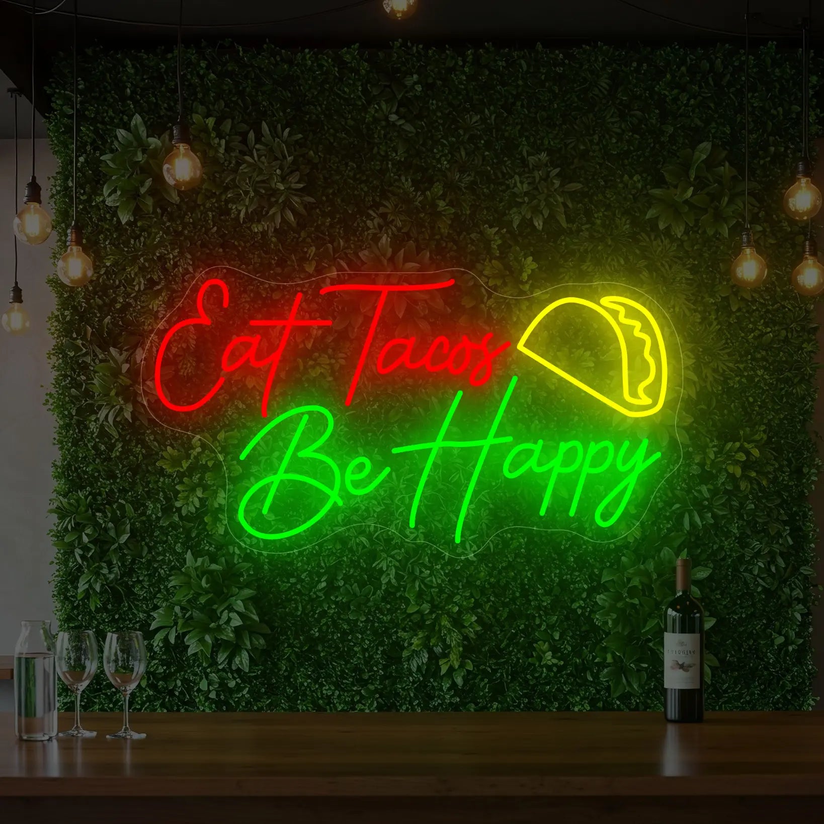 Photo of the 'EAT TACOS BE HAPPY' neon sign glowing in multi-color against a styled interior wall.