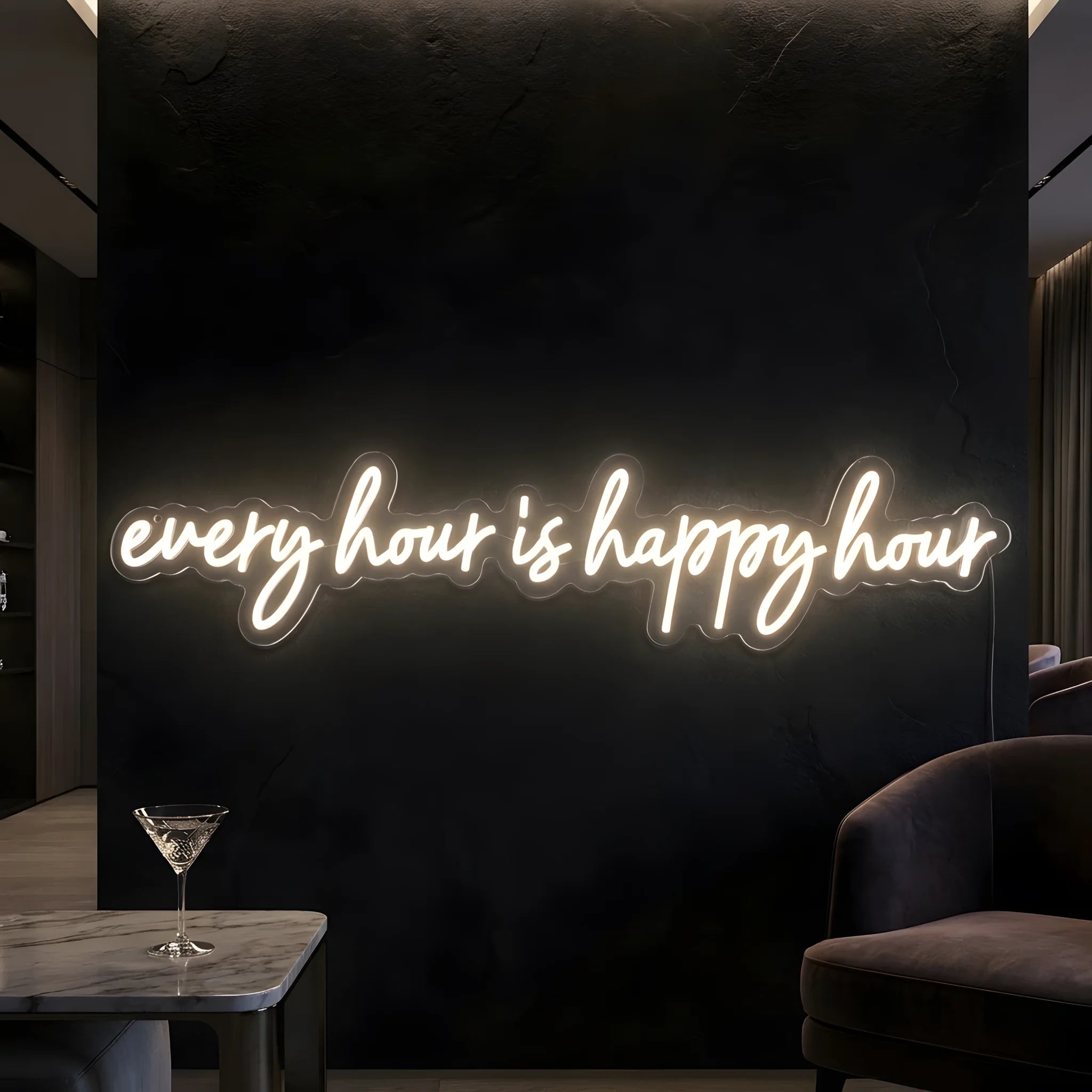 Photo of the 'Every Hour Is Happy Hour' neon sign glowing in warm white against a styled interior wall.
