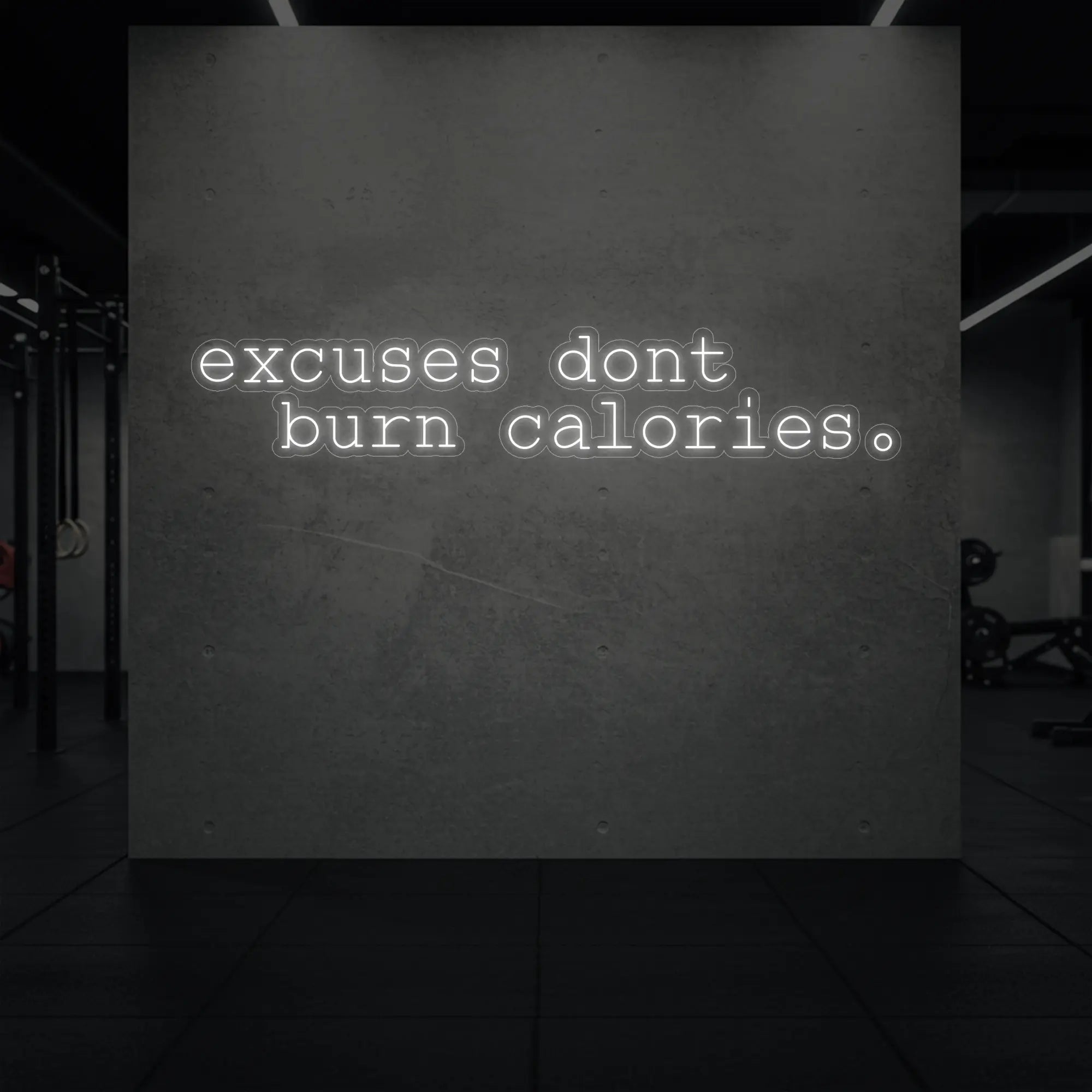 'Excuses Don’t Burn Calories' neon sign glowing in cool white against a styled interior wall.