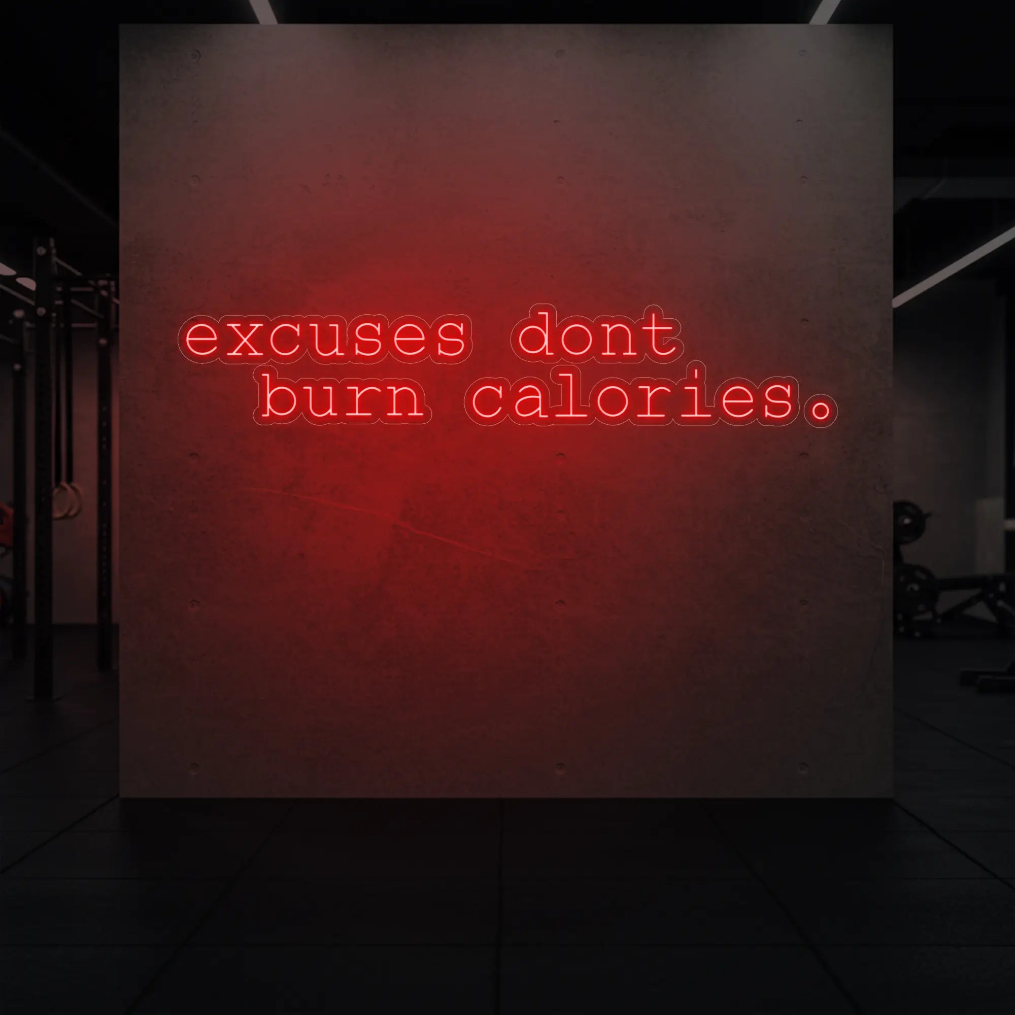 'Excuses Don’t Burn Calories' neon sign glowing in red against a styled interior wall.