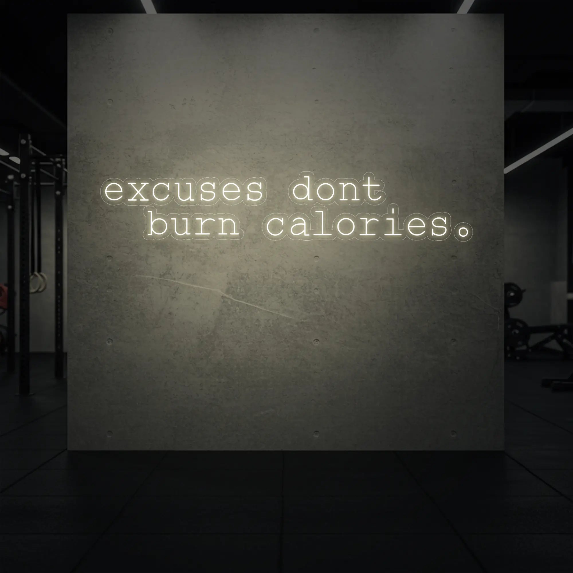 'Excuses Don’t Burn Calories' neon sign glowing in warm white against a styled interior wall.