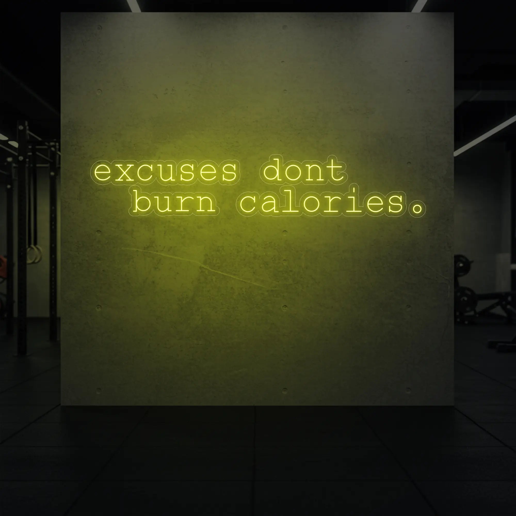  'Excuses Don’t Burn Calories' neon sign glowing in lemon yellow against a styled interior wall.