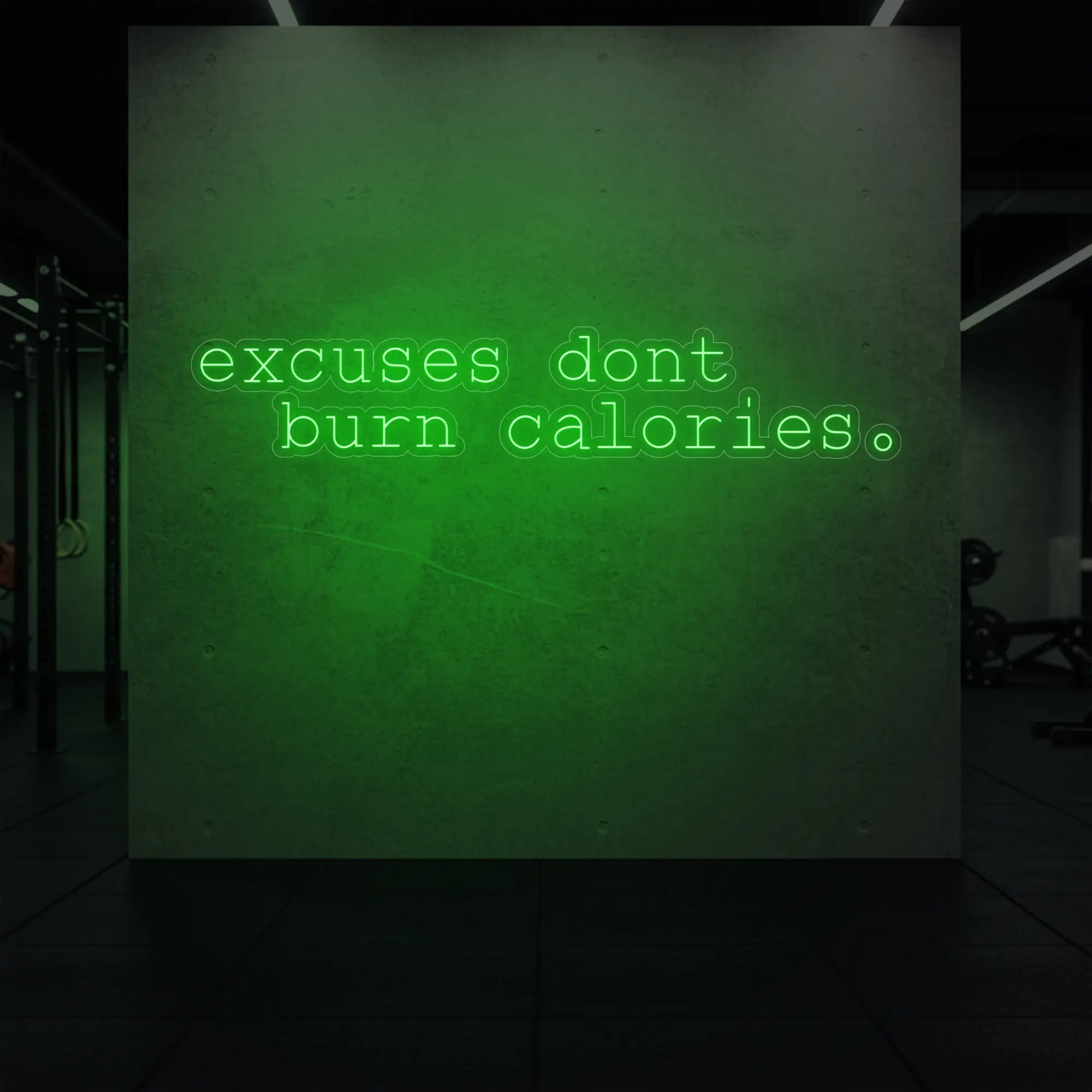 'Excuses Don’t Burn Calories' neon sign glowing in green against a styled interior wall.