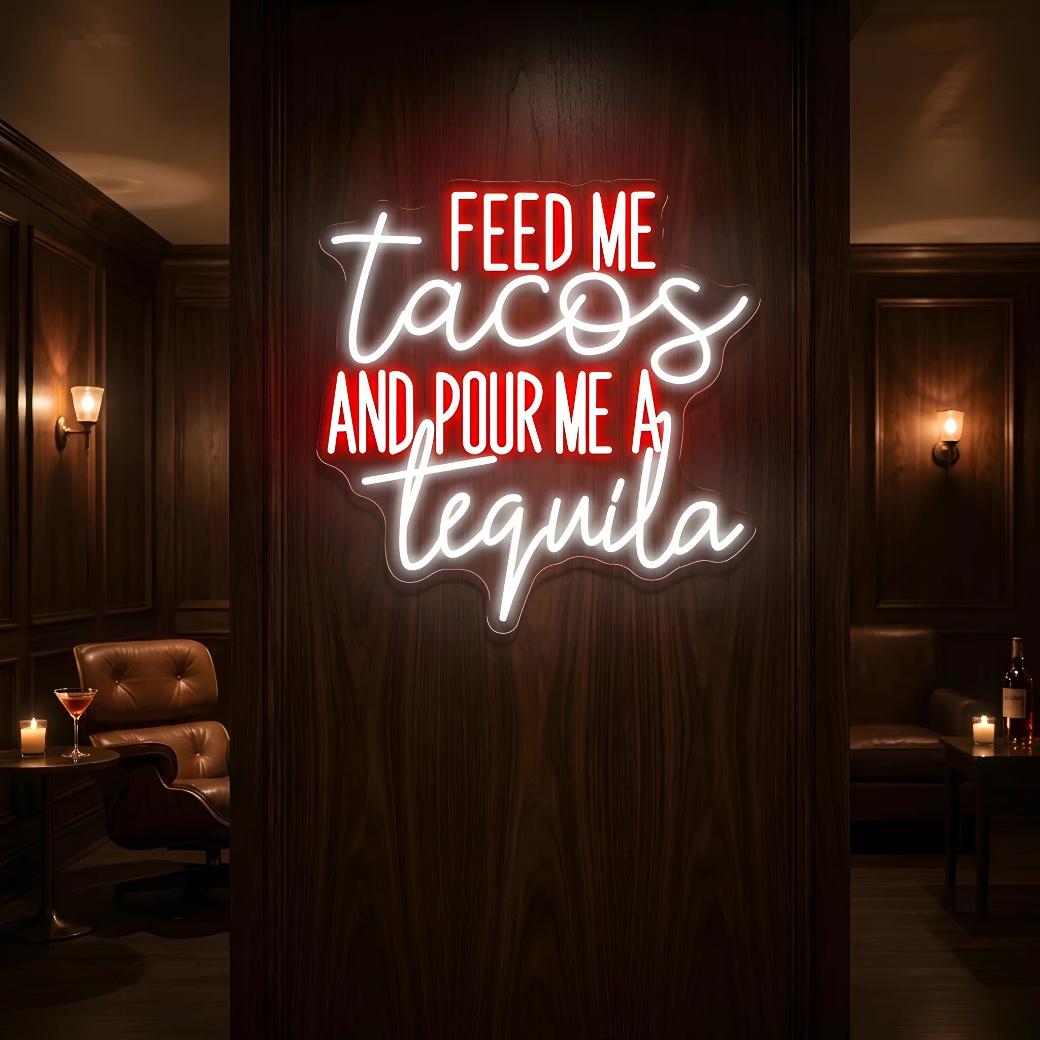 Photo of the 'Feed Me Tacos and Pour Me a Tequila' neon sign glowing in multi-color against a styled interior wall.