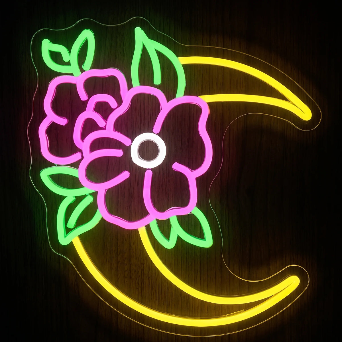 Floral crescent moon LED neon sign with yellow, pink, green and white illumination on clear acrylic backing.