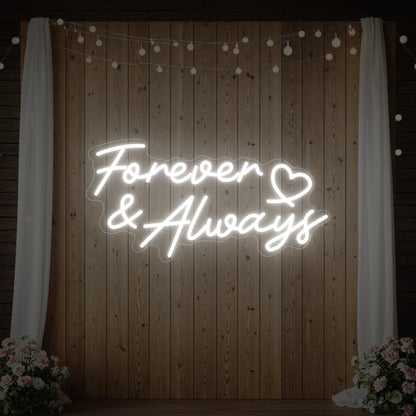 Photo of the 'Forever & Always' neon sign glowing in cool white against a styled interior wall.