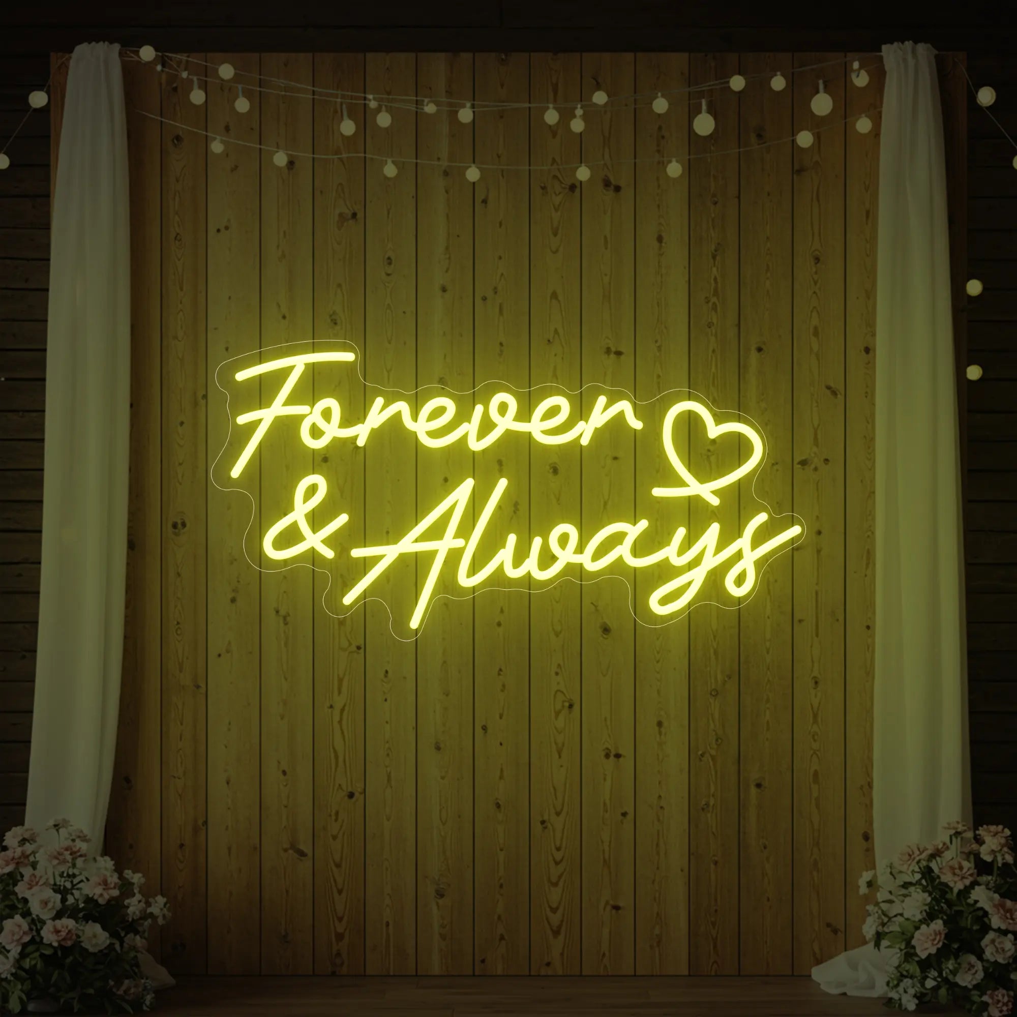 Photo of the 'Forever & Always' neon sign glowing in lemon yellow against a styled interior wall.