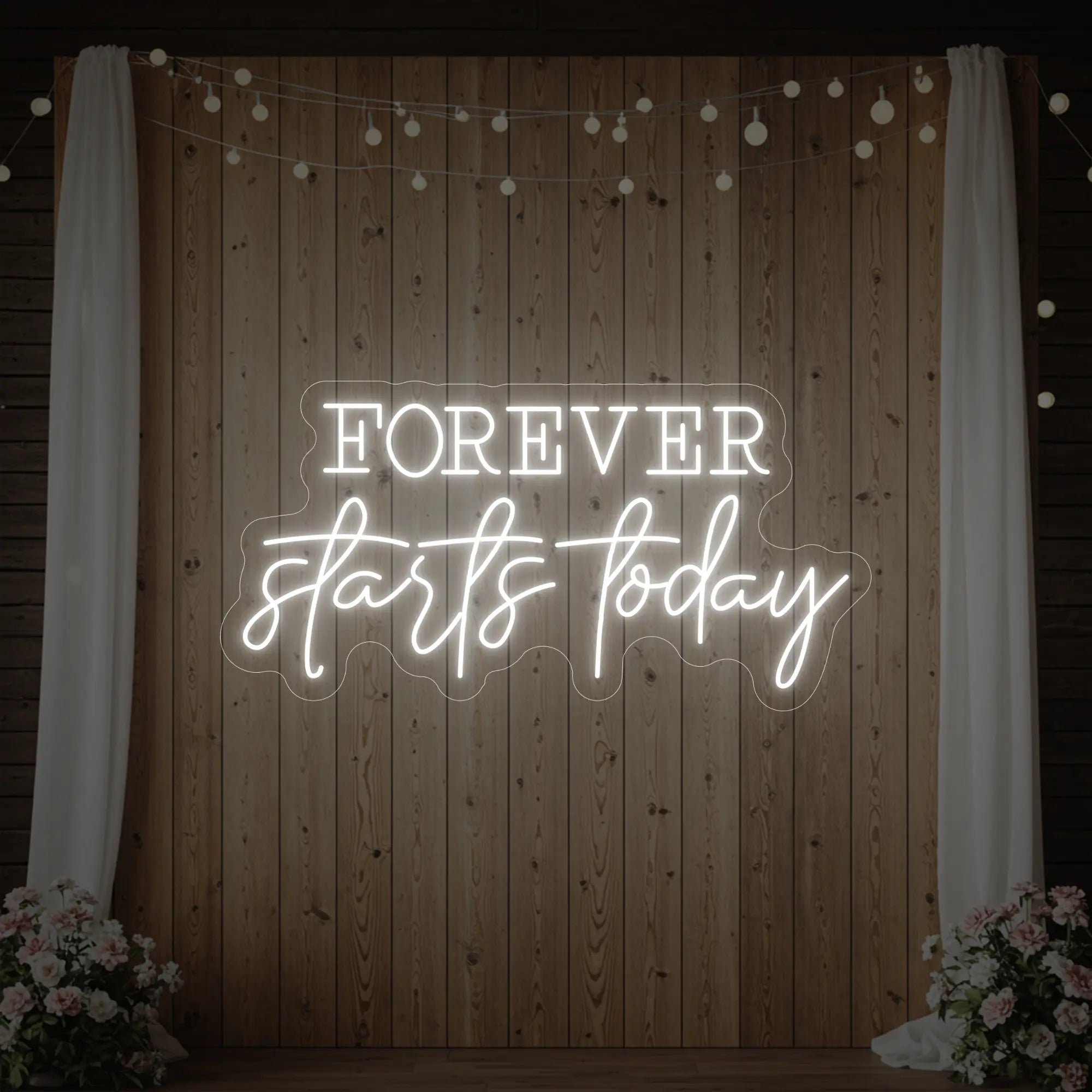 Photo of the 'Forever Starts Today' neon sign glowing in cool white against a styled interior wall.
